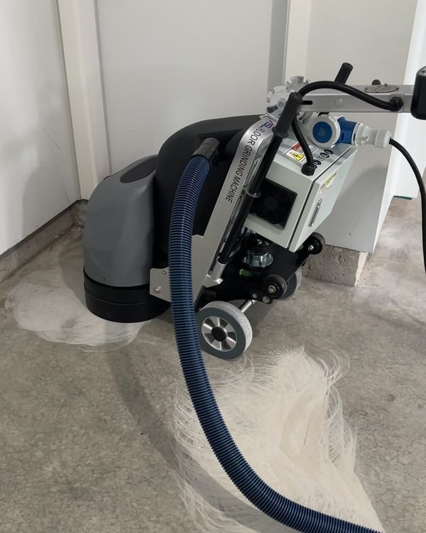 Diamond grinding a garage slab with dust extraction