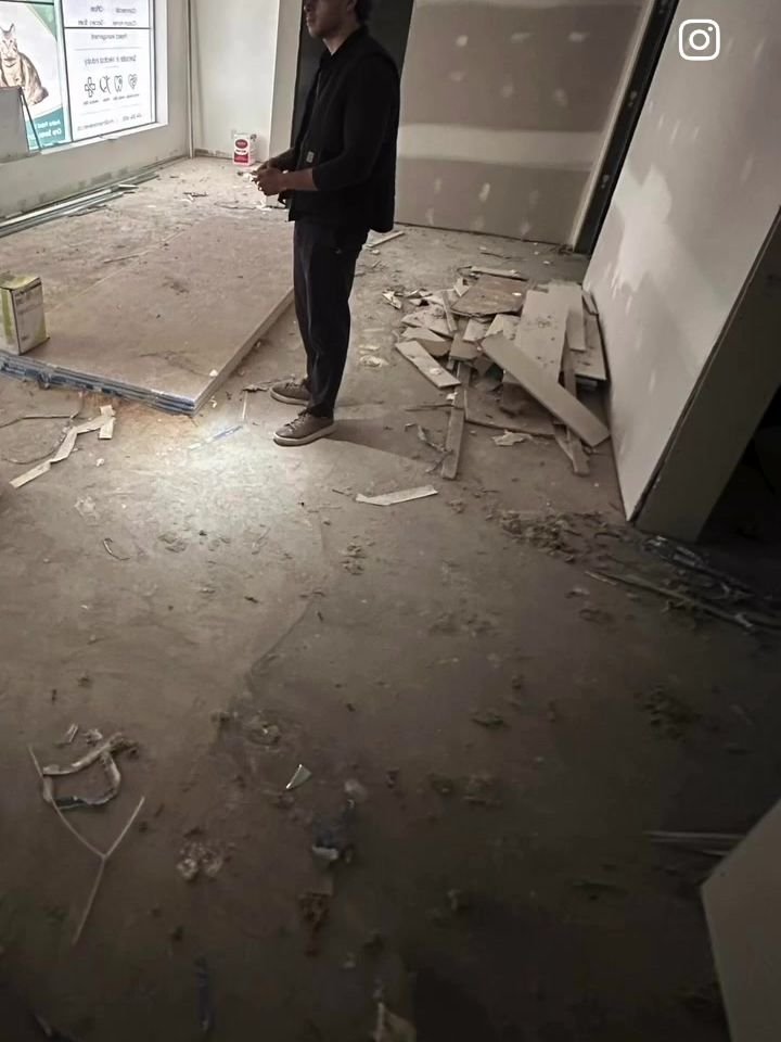 Before: old flooring torn up and debris on the concrete slab of a Tsawwassen veterinary clinic