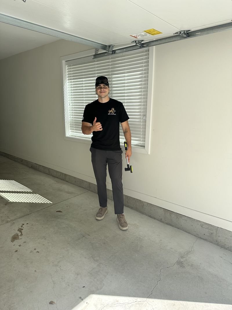Oakley from Wish Coatings giving a thumbs up in a customer’s garage before a floor coating job